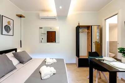 a living room with a bed and a table at Suite Room Suriani in Rome