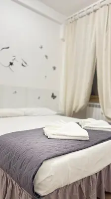 a bed with two white pillows on top of it at Casa Roma in Rome