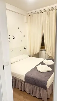 a bedroom with a bed and a window at Casa Roma in Rome