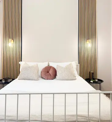 a bedroom with a white bed with two pillows at Vatican Exclusive Suite in Rome