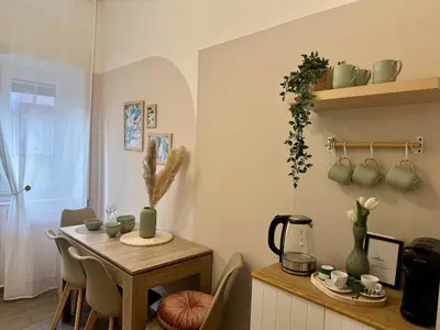 a dining room with a table and a table and a kitchen at Vatican Exclusive Suite in Rome