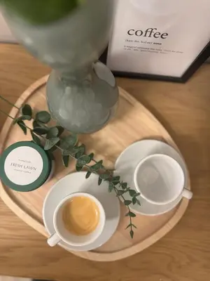 two cups of coffee on a wooden tray with a coffee machine at Vatican Exclusive Suite in Rome