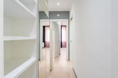 a hallway with white walls and a glass door at Silver Dream Cornelia, Elegant Apt with Car Park in Rome