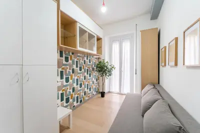 a living room with a couch and a wall of tiles at Silver Dream Cornelia, Elegant Apt with Car Park in Rome