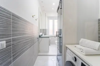 a white bathroom with a sink and a washing machine at Silver Dream Cornelia, Elegant Apt with Car Park in Rome