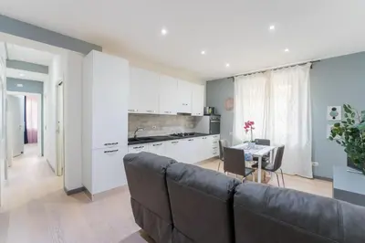 a living room with a couch and a kitchen at Silver Dream Cornelia, Elegant Apt with Car Park in Rome