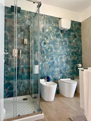 a bathroom with a shower and a toilet and a sink at Monti Tiburtini Roma Guest House in Rome