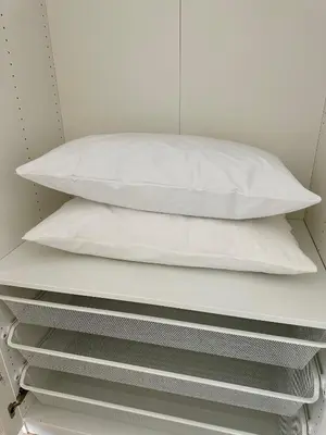 a stack of white pillows sitting on a shelf at Monti Tiburtini Roma Guest House in Rome