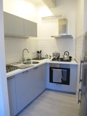 a white kitchen with a sink and a stove at Spacious, Modern, Bright Apartment, near Piazza Navona! in Rome