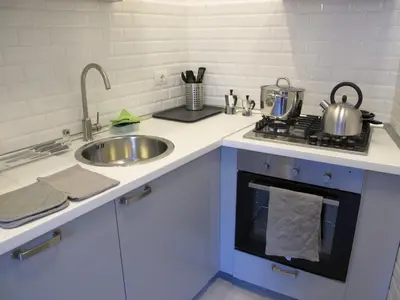 a kitchen counter with a sink and a stove at Spacious, Modern, Bright Apartment, near Piazza Navona! in Rome