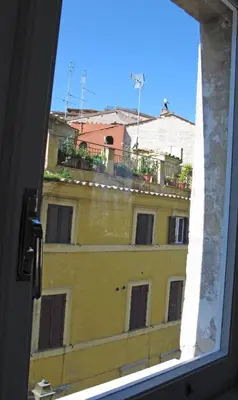 a view of a yellow building from a window at Spacious, Modern, Bright Apartment, near Piazza Navona! in Rome
