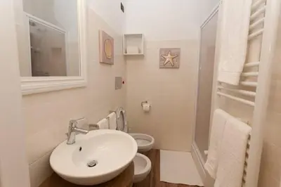 a bathroom with a sink and two toilets at Rome Eternal City in Rome