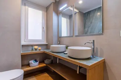 a bathroom with two sinks and a toilet at Cyprus - Roma's Delightful Lodges in Rome