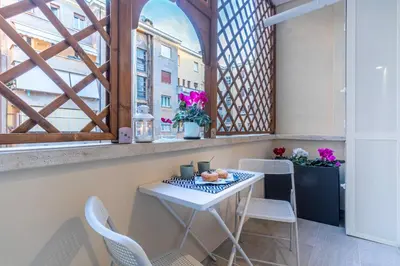 a balcony with a table and chairs and a window at Cyprus - Roma's Delightful Lodges in Rome