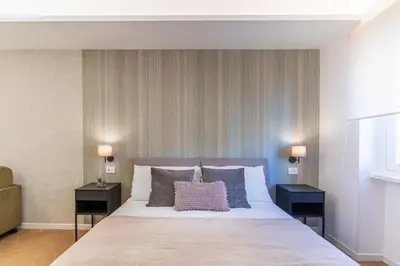 a bedroom with a large bed with two night stands at Cyprus - Roma's Delightful Lodges in Rome