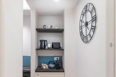 a clock hanging on a wall in a room at Cyprus - Roma's Delightful Lodges in Rome