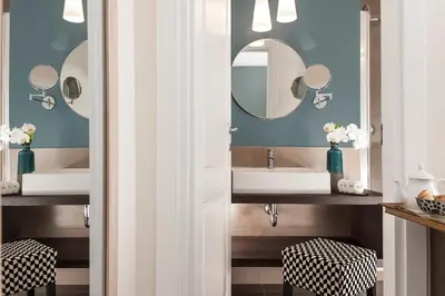 a bathroom with two sinks and two mirrors at Corso Vittorio 308 in Rome