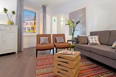 a living room with a couch and two chairs at Corso Vittorio 308 in Rome
