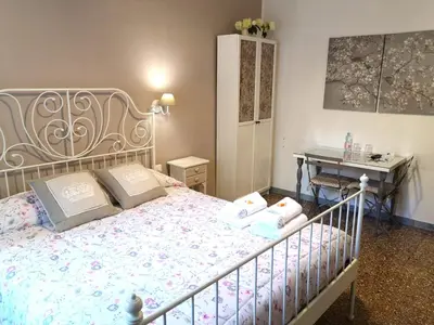 a bedroom with a bed with two pillows and a desk at La Chiave di Roma in Rome
