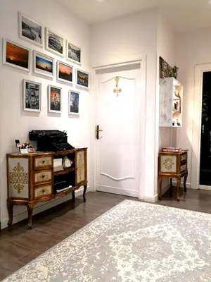 a room with a door and a dresser and pictures on the wall at La Chiave di Roma in Rome