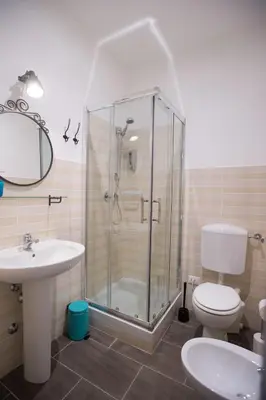 a bathroom with a shower and a toilet and a sink at La Chiave di Roma in Rome
