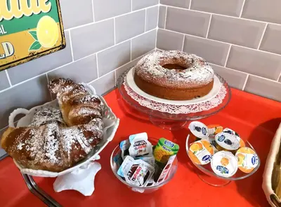 a table with a cake and some pastries on it at La Chiave di Roma in Rome