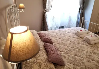 a bedroom with a bed with a lamp and a window at La Chiave di Roma in Rome