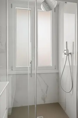 a bathroom with a shower and two windows at Urban Loft - San Giovanni by RHR in Rome