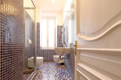 a bathroom with a toilet and a sink at LCGrandTour Donatello in Rome