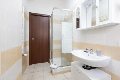 a bathroom with a sink and a shower at Affittacamere Alpino 76 in Rome