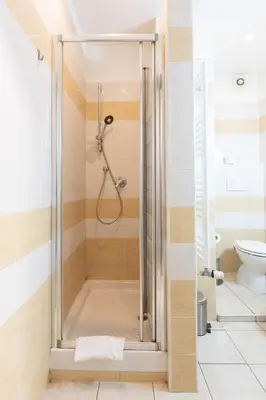 a shower with a glass door in a bathroom at Affittacamere Alpino 76 in Rome