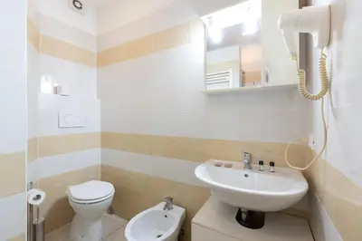 a bathroom with a white toilet and a sink at Affittacamere Alpino 76 in Rome