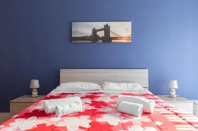 a bedroom with a large bed with a bridge at Affittacamere Alpino 76 in Rome