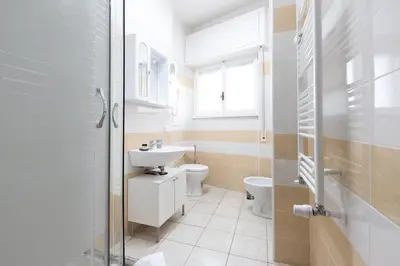 a bathroom with a sink and a toilet at Affittacamere Alpino 76 in Rome