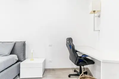 a living room with a desk and a chair at The Trastevere Apartment in Rome
