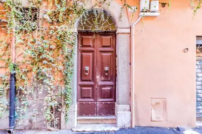an entrance to a building with a brown door at The Trastevere Apartment in Rome