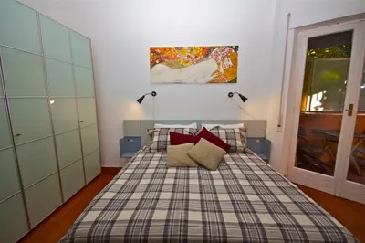 a bedroom with a bed with two red pillows at PORTA PORTESE apartment in Rome