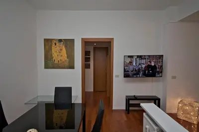 a living room with a table and a picture on the wall at PORTA PORTESE apartment in Rome