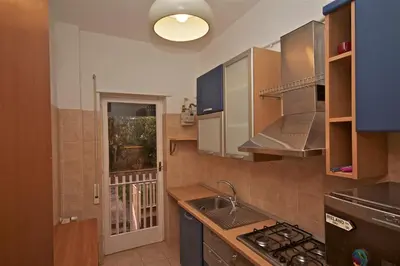 a kitchen with a sink and a stove top oven at PORTA PORTESE apartment in Rome