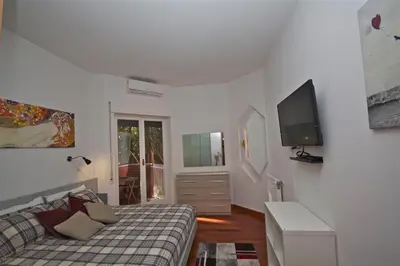 a living room with a couch and a tv at PORTA PORTESE apartment in Rome