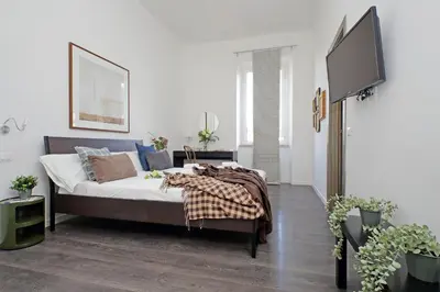 a bedroom with a bed and a flat screen tv at St Peter Giant Apartment in Rome