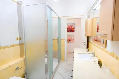 a bathroom with two sinks and a shower at Elegantis Giolitti Suite Apartment with Private Balcony in Rome