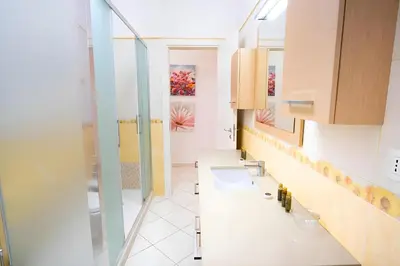 a bathroom with two sinks and a shower at Elegantis Giolitti Suite Apartment with Private Balcony in Rome