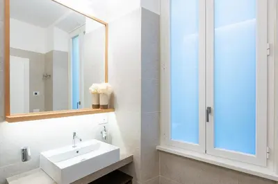 a bathroom with a sink and a mirror at ARIOSTO'S Luxury Rooms in Rome