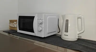 a microwave and a blender sitting on a counter at Gregorio VII Dream House in Rome