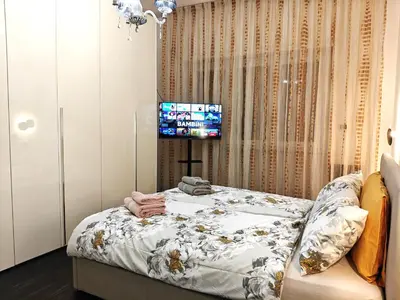 a bedroom with a bed and a tv in it at Gregorio VII Dream House in Rome