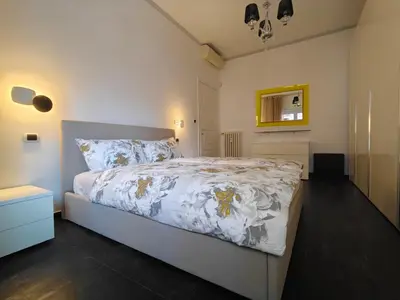 a bedroom with a bed with a white comforter at Gregorio VII Dream House in Rome
