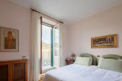 a bedroom with a bed and a large window at Tomas' house Clodio in Rome