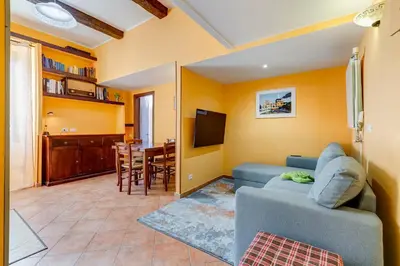 a living room with a blue couch and a tv at Casa Garbha in Rome