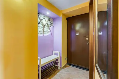 a hallway with yellow and purple walls and a door at Casa Garbha in Rome
